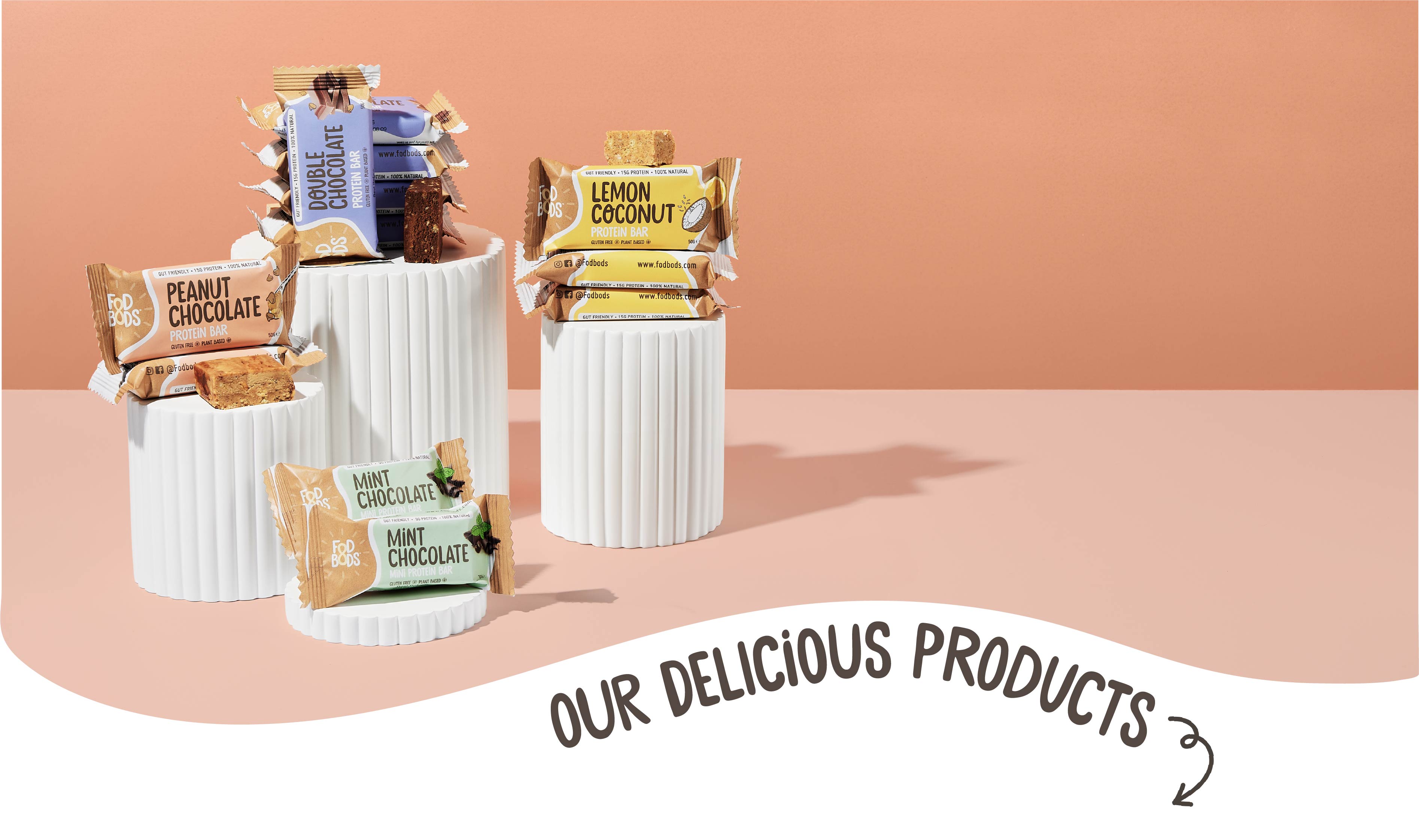 Fodbods Protein bars in white containers on a peach background 