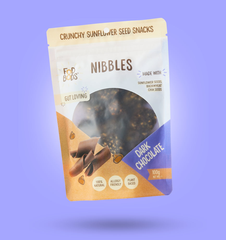 Dark Chocolate Nibbles 100g Package on Purple Background