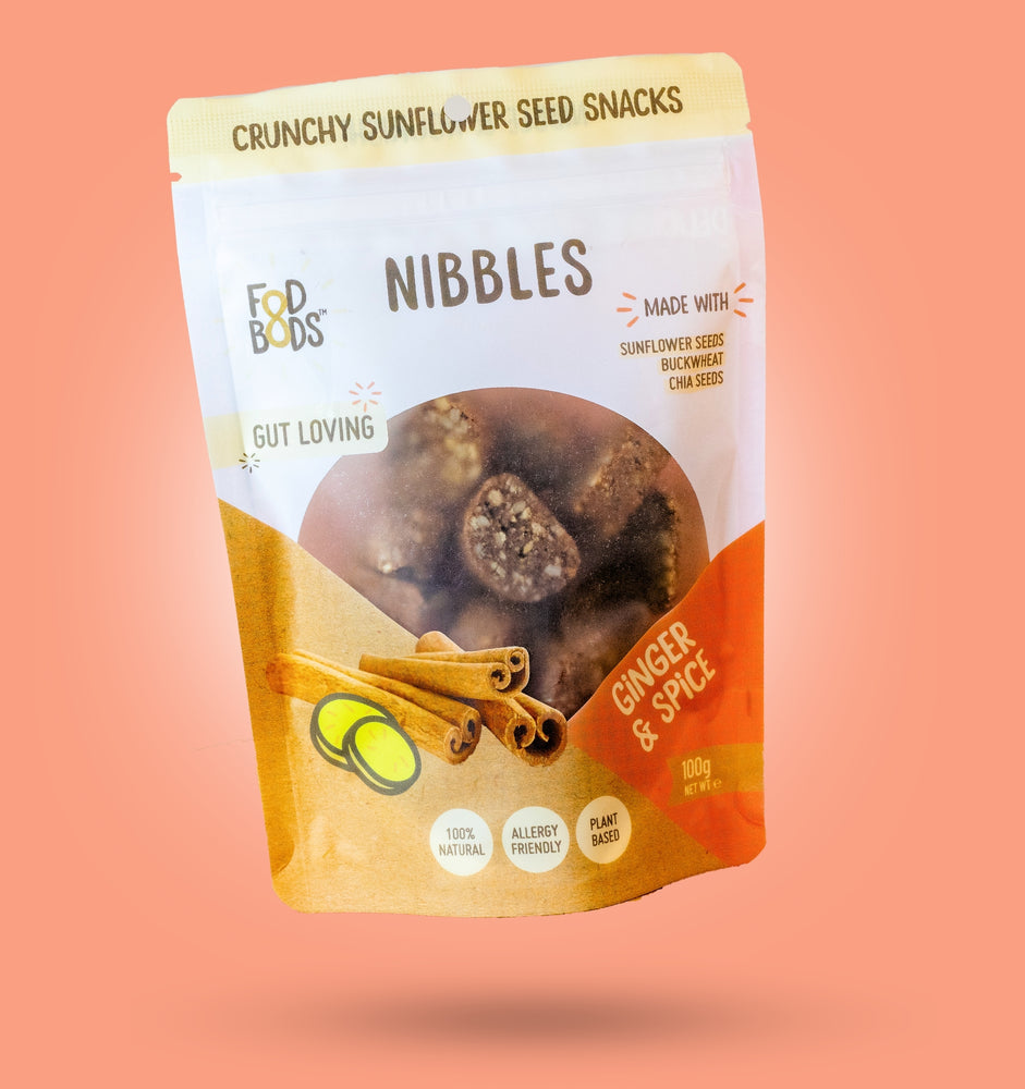 Ginger & Spice Nibbles 100g Package on Orange Background